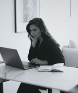 Young woman working on a laptop in a bright office