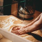 Close-up of a baker's hands shaping dough