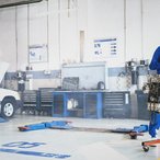 Mechanic working on an engine in an auto repair shop