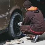 Mechanic changing a car wheel in a repair shop
