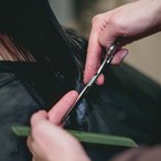 Close-up of a hairdresser's scissors and comb mid-cut