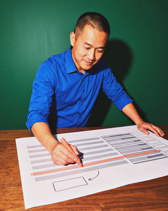 A sales lead crosses one line off a printed plan with a marker.